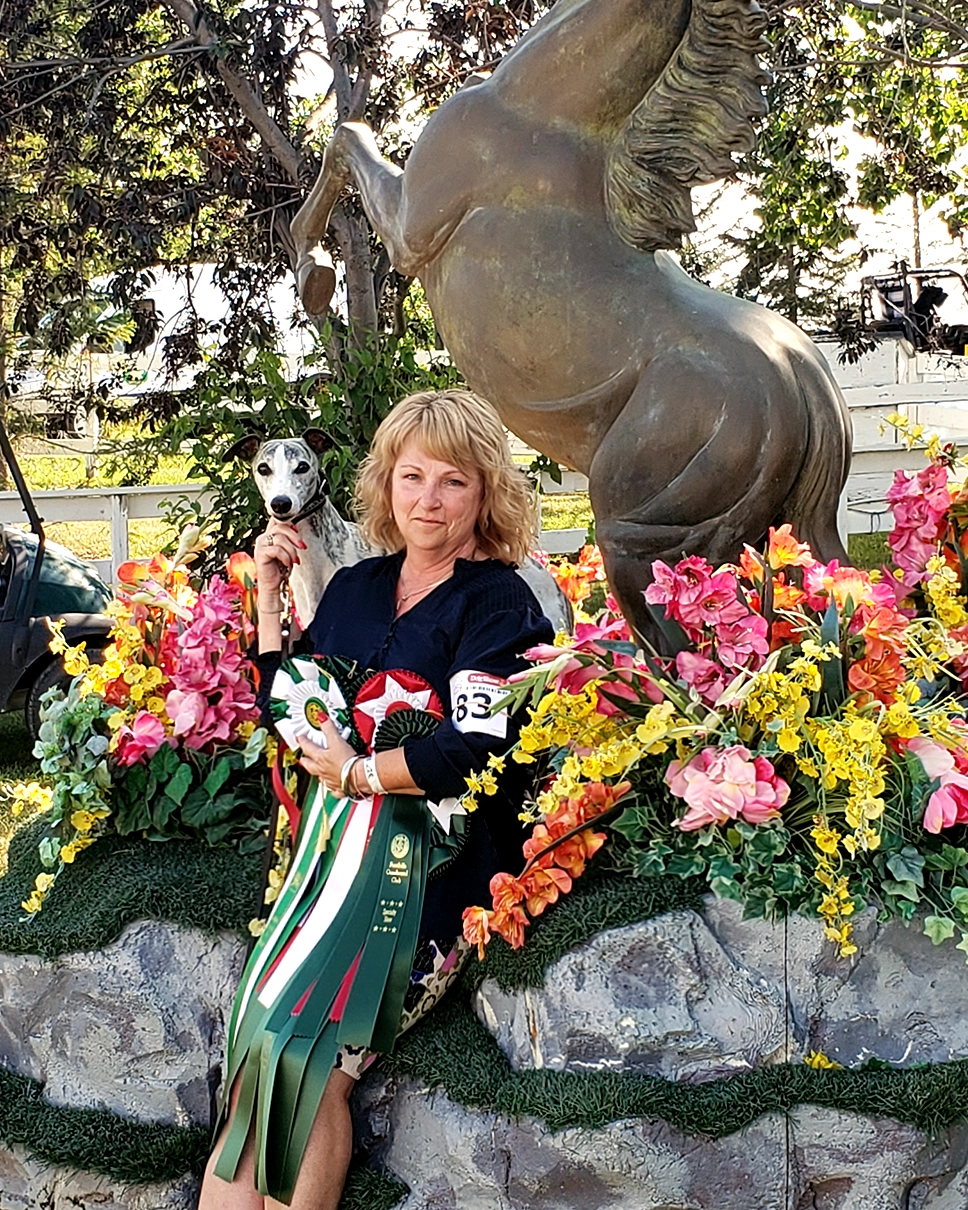 Photo of Karen and Amore by a horse statue